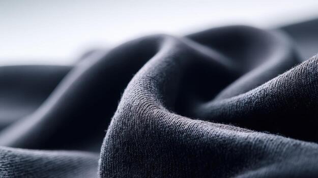 Close-Up Shot of a Dark Gray Cotton Fabric, Showing Texture, Folds, and Softness photo