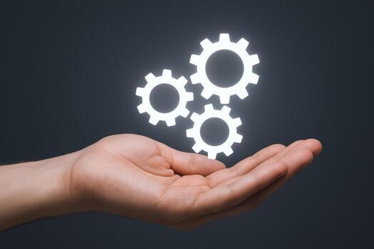 Hand Presenting Glowing Gears Concept for Innovation, Technology, Solutions, and Engineering on Dark Background photo