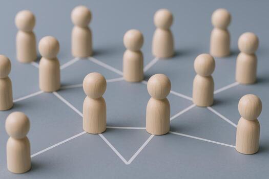 Social Network Connection Concept with Wooden Figures Representing Teamwork and Collaboration on Blue Background photo