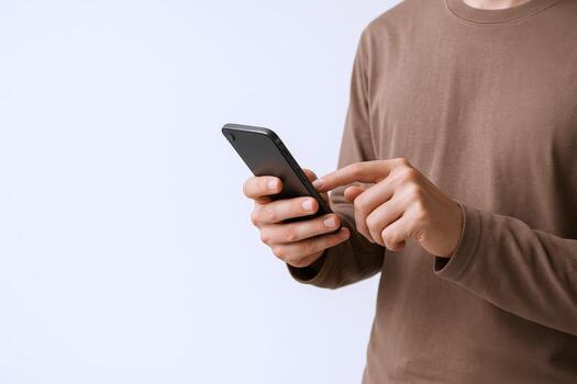 Man Using Smartphone for Communication, Browsing, Social Media, and Mobile Applications in a Studio Shot photo