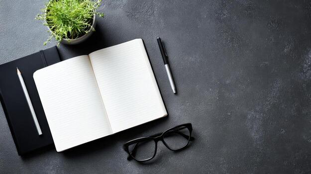 Workspace Flat Lay with Open Notebook, Pen, Glasses, and Plant on Dark Textured Surface photo