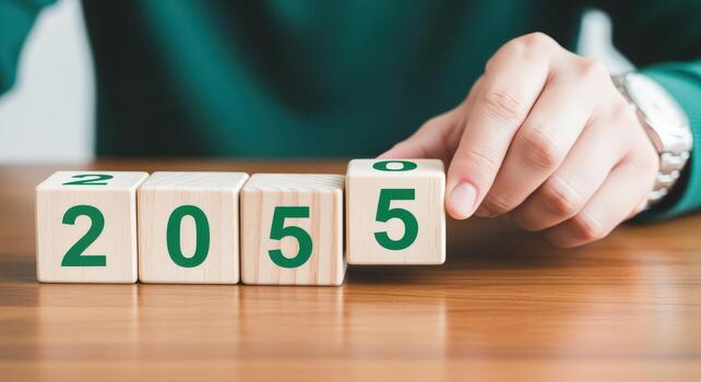 Hand placing wooden block to change year to 2055, future planning and forecasting concept photo