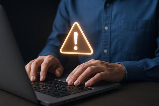 Man Typing on Laptop with Warning Sign Overlay Cybersecurity, Alert, and Attention Concepts photo