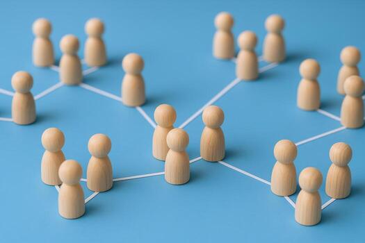 Wooden Figures Connected by Lines, Symbolizing Social Network, Communication, Community, and Relationships on Blue Background photo