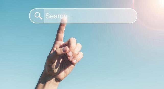 Searching Online A Hand Taps a Virtual Search Bar Against a Clear Blue Sky Backdrop photo