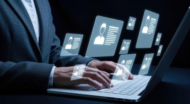 Human Resources Professional Reviewing Candidate Profiles on Laptop with Digital Interface in Modern Office photo