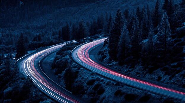 Nighttime Highway Curves Through Mountains with Light Trails and Dark Forest Scenery photo