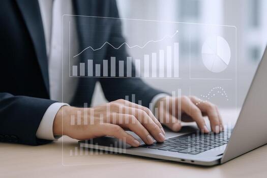 Professional using laptop for financial analysis with data analytics and growth charts, modern workplace photo