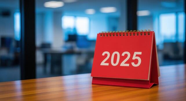Red Desk Calendar Displaying 2025 on Wood Table in Modern Office, Forecasting Future Planning and Preparation photo