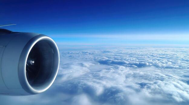 Aerial View from Airplane Window of Engine Above Clouds on a Sunny Day photo