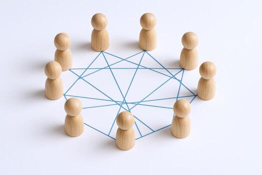 Conceptual Circle of Wooden Figures Connected by Lines Symbolizing Teamwork, Networking, and Collaboration photo