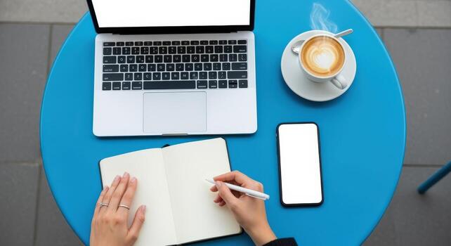 Workspace Flat Lay Laptop, Mobile Phone, Coffee, and Notebook on a Vibrant Blue Table photo
