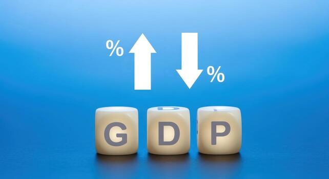 GDP Growth and Decline Concept with Up and Down Arrows on Wooden Blocks Against Blue Background photo