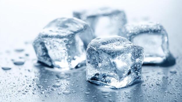 Close-up of Melting Ice Cubes with Water Droplets on a Reflective Metallic Surface photo