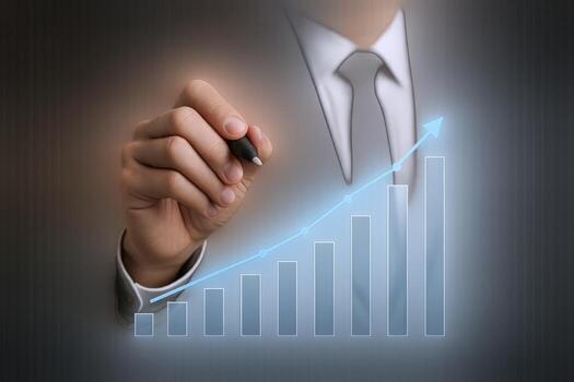 Businessman Hand Drawing an Upward Graph, Visualizing Growth and Success in Business on a Black Background photo