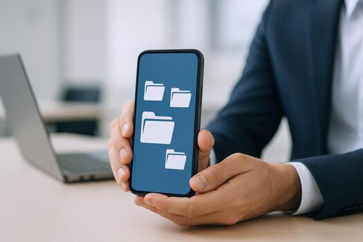 Man Holding Smartphone Displaying File Folders, Representing Data Management and Mobile Technology Integration photo