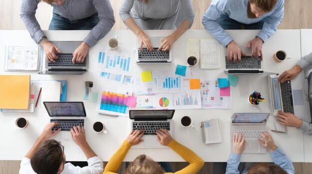 Collaborative Teamwork in Modern Office Diverse Professionals Working Together on Laptops, Sharing Ideas and Data photo