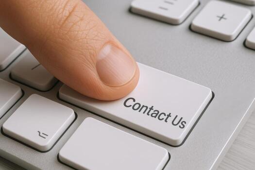 Close-up of Finger Pressing Contact Us Button on Keyboard, Represents Digital Communication and Support photo