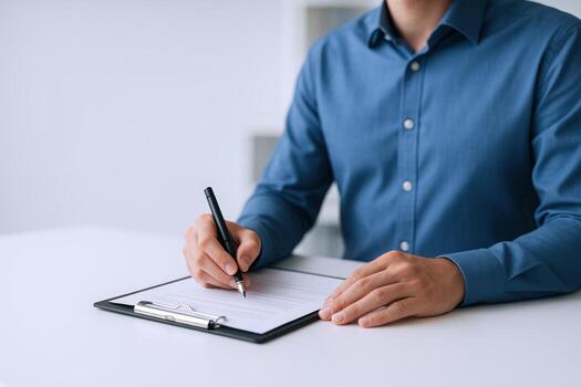 Man filling out form on clipboard, signing document for business or legal purposes in office photo