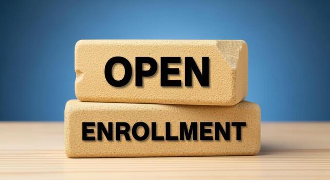 Open enrollment message on wooden blocks against blue backdrop, symbolizing opportunity for selection and participation photo