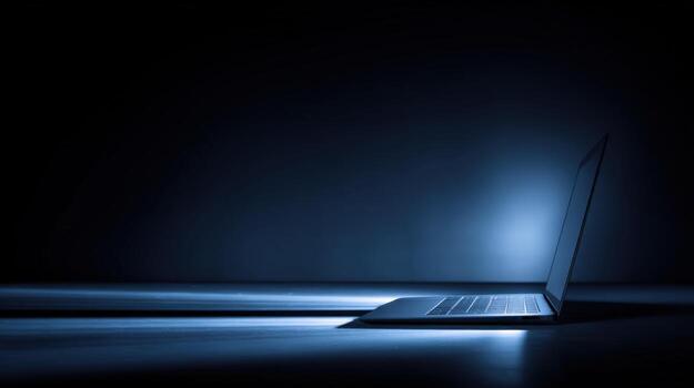 Laptop in Dark Blue Room Showing Technology and Modern Design for Business or Personal Use photo