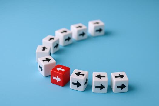 Conceptual Leadership Red Cube Leading White Cubes with Arrows in a Semicircle on Blue Background photo