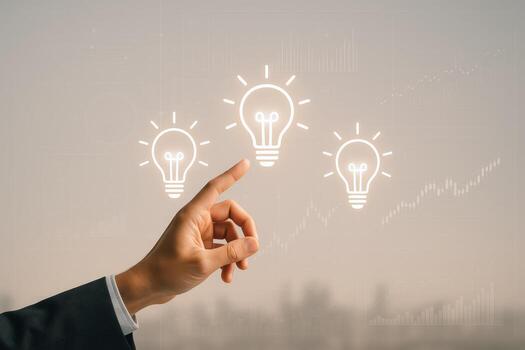 Innovation Concept Hand Pointing at Illuminated Light Bulbs Representing Ideas and Business Growth on Abstract Background photo