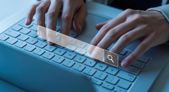 Hands Typing on Laptop Keyboard with Search Bar Overlay for Online Information Access photo
