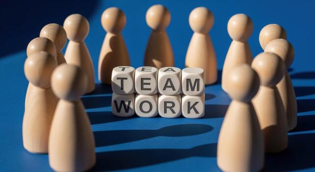 Teamwork Concept with Wooden Figures Surrounding Blocks Spelling Teamwork, Representing Collaboration and Unity photo