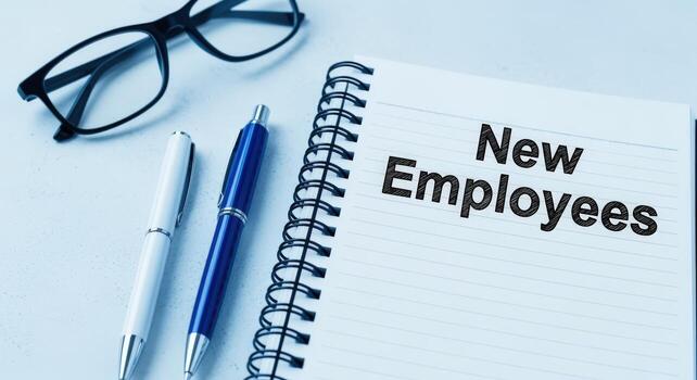 Onboarding New Employees A Notepad with Pen and Eyeglasses Ready for a Successful Startup photo