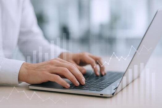 Close-up of Hands Typing on Laptop with Financial Chart Overlay for Business and Technology Concepts photo