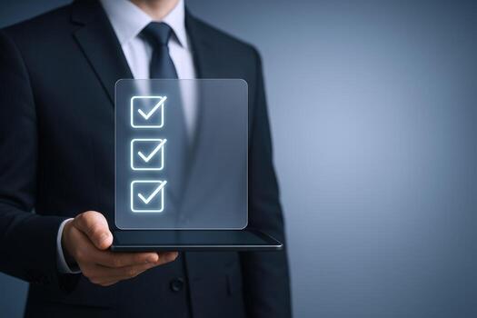 Businessman Holding Digital Tablet Displaying Checklist Icons For Task Management And Business Compliance photo