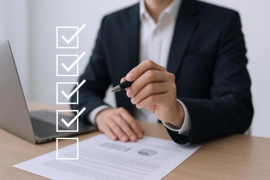 Businessman Reviewing Checklist with Pen and Laptop, Representing Task Completion and Business Management photo