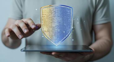 Data protection concept Man using digital tablet with shield, internet security and safety photo