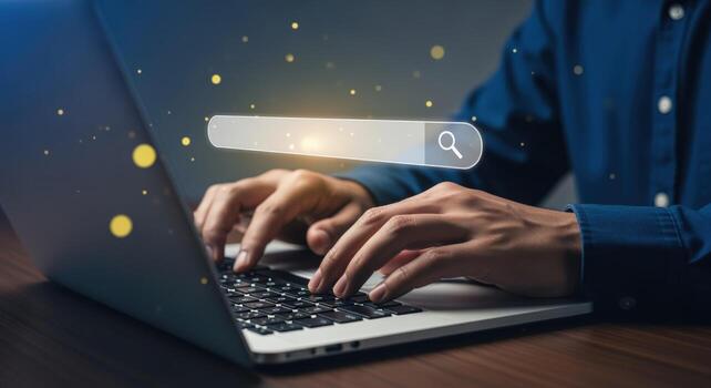 Person Typing on Laptop with Search Bar Overlay, Representing Internet Research and Online Information Access photo