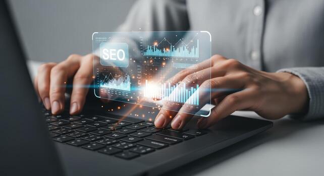 Hands on Laptop Keyboard Analyzing SEO Data with Modern Holographic Interface Display photo