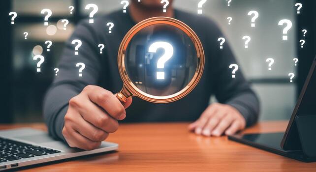 Person Holding Magnifying Glass Over Question Marks, Illustrating Inquiry, Research, and Problem Solving photo
