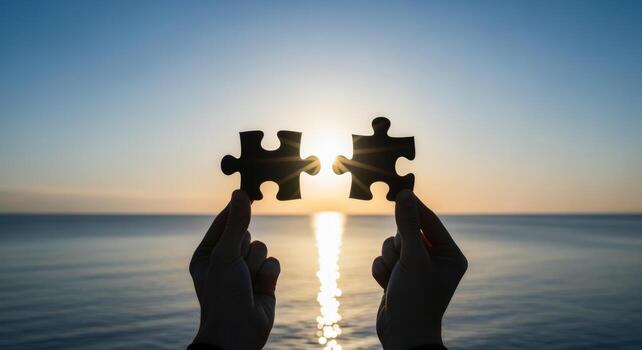Silhouette Hands Holding Jigsaw Puzzle Pieces Against Sunset Over Ocean, Symbolizing Unity and Completion photo