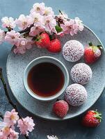 Delicate Spring Blossoms Adorn a Refreshing Strawberry and Tea Treat. photo
