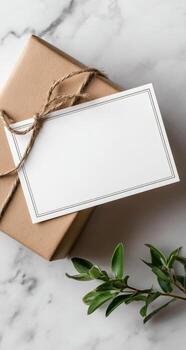 Gift box with blank card and twine on marble background photo