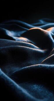 A dark blue blanket with a light shining through it photo
