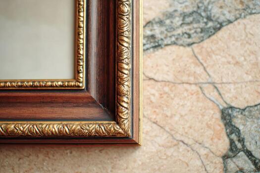 A mirror with a gold frame on a wall photo