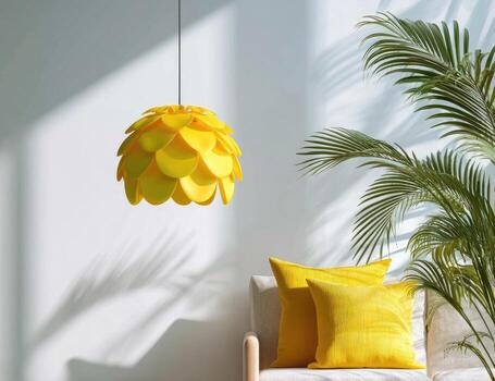A yellow lamp hangs from the ceiling in front of a white couch photo
