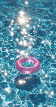 A pink ring floating in a pool of water photo