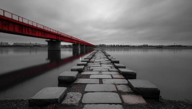 A red bridge over water with a path leading to it photo