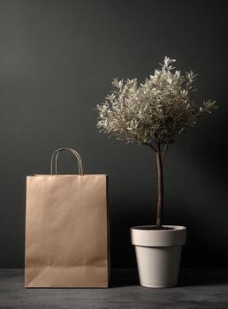 Paper bag and potted tree on black background photo