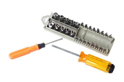 Screwdriver set with interchangeable bits and socket heads isolated on white background. Essential toolkit for home repair, DIY projects, mechanics, and professional construction work. photo