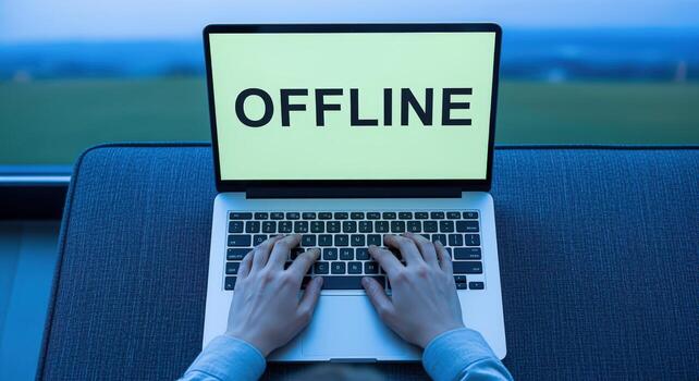 Offline Laptop Screen Displaying Connection Status, Hands Typing on Keyboard, Person Using Computer photo