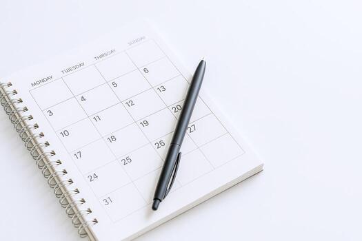 Calendar Page and Pen Mockup on a Clean White Surface for Business Planning and Scheduling photo