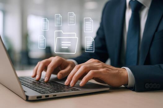 Businessman managing digital documents on a laptop, representing data management and workflow efficiency in the modern workplace photo